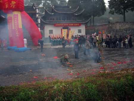 参加盛典的人们从四面八方来到了宗祠广场，欢迎的鞭炮响起。